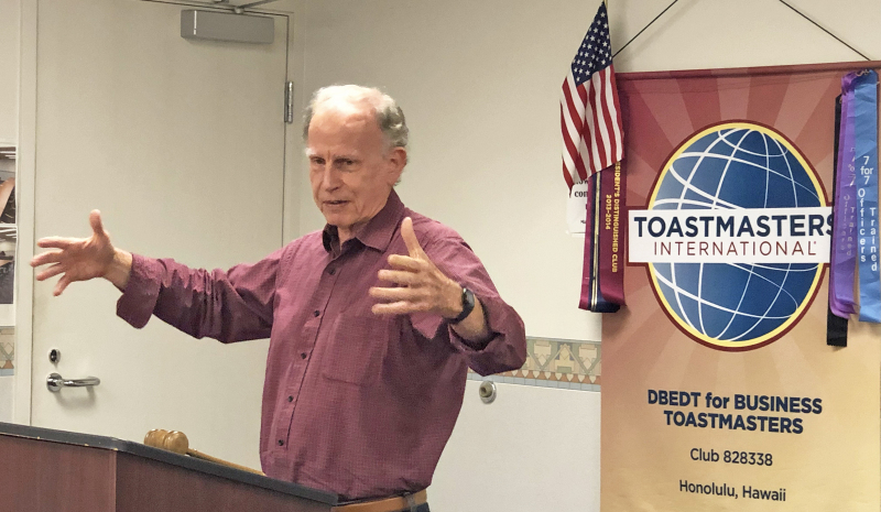 Speaker using expressive gestures to effectively communicate his message.